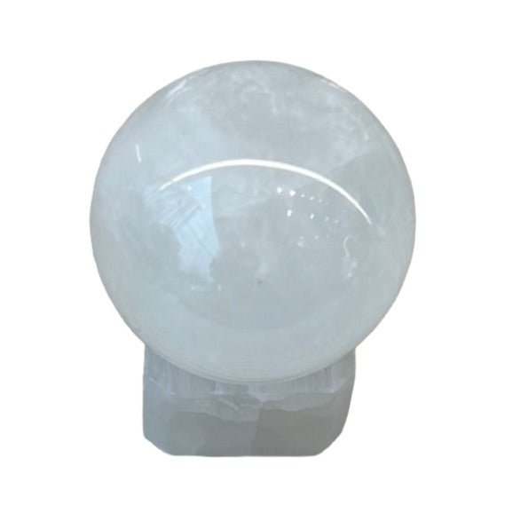 Optical Calcite Sphere 72g on a block, promotes healing, stress relief, and enhances intuition in a harmonious environment.