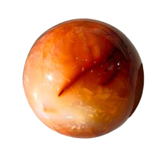 Carnelian sphere 338g, promoting vitality, creativity, and healing while stimulating sexuality and fertility.