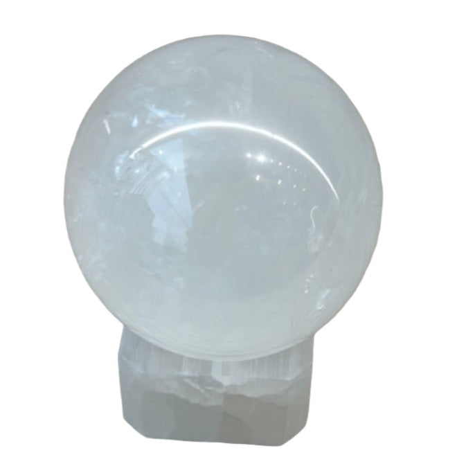 Optical Calcite Sphere 88g on a clear base, promoting healing, stress relief, and intuition in a balanced environment.