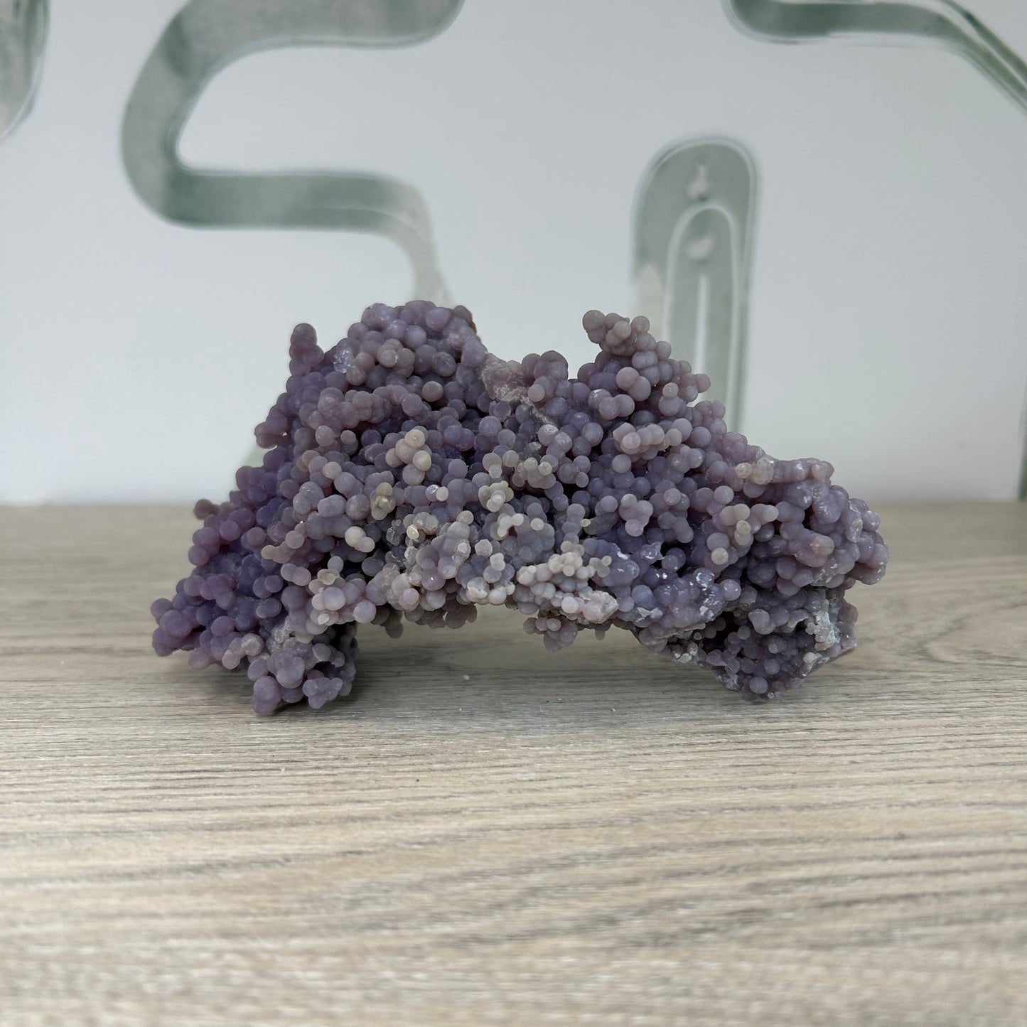 Grape Agate Free Form crystal on wooden surface, known for healing properties, stress relief, and meditation use, approx 279g.