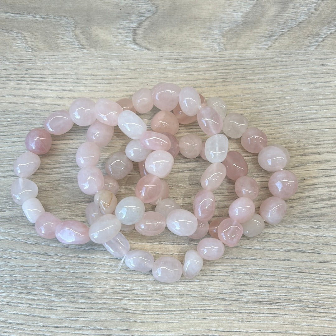 Rose Quartz Tumbled Stone Bracelets for self-confidence and love on wooden surface.