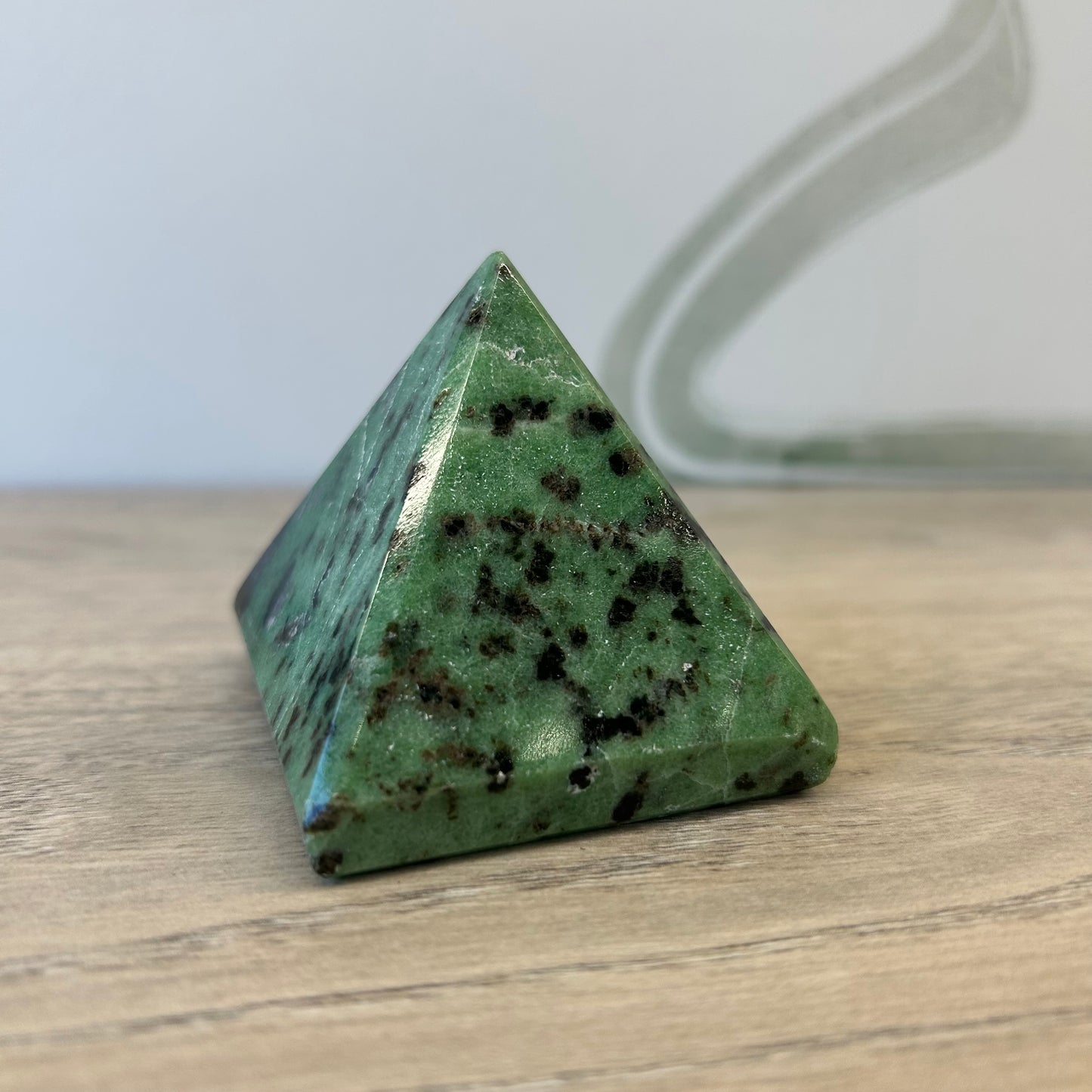 Ruby Zoisite pyramid showcasing a stunning green and black crystal texture, promoting positivity and creativity.