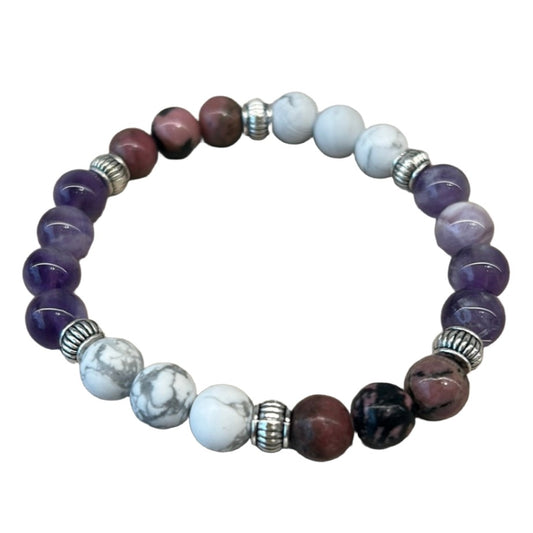 Colorful beaded bracelet featuring purple and white stones, designed to promote sleep and tranquility.