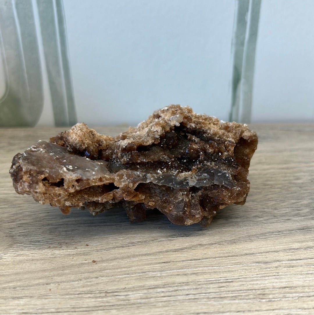 Raw Citrine Druze 193g crystal showcasing natural beauty and energizing properties on wooden surface.