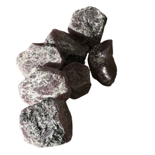 Ruby hexagon rough stones promoting passion, motivation, and positive energy in a natural display.