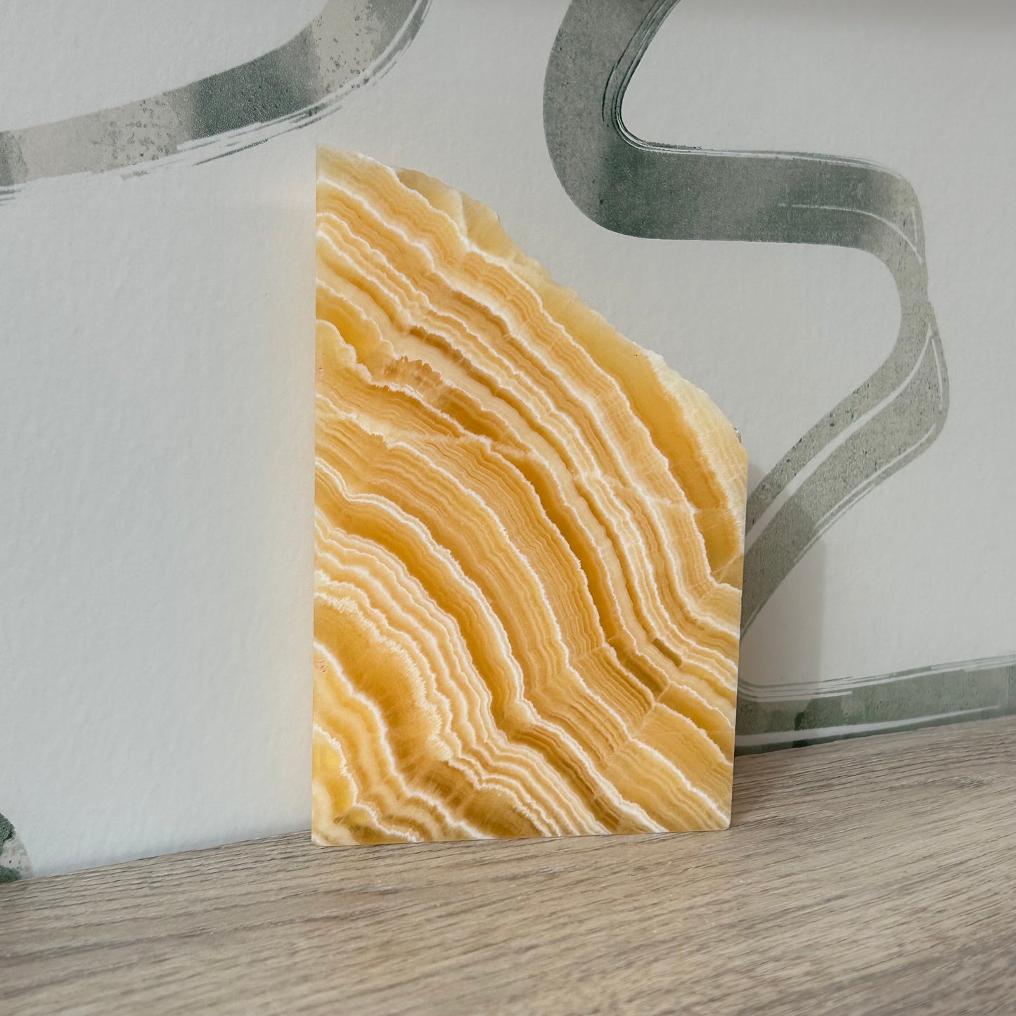 Orange calcite slab showcasing beautiful natural patterns, perfect for enhancing energy and decor in any space.