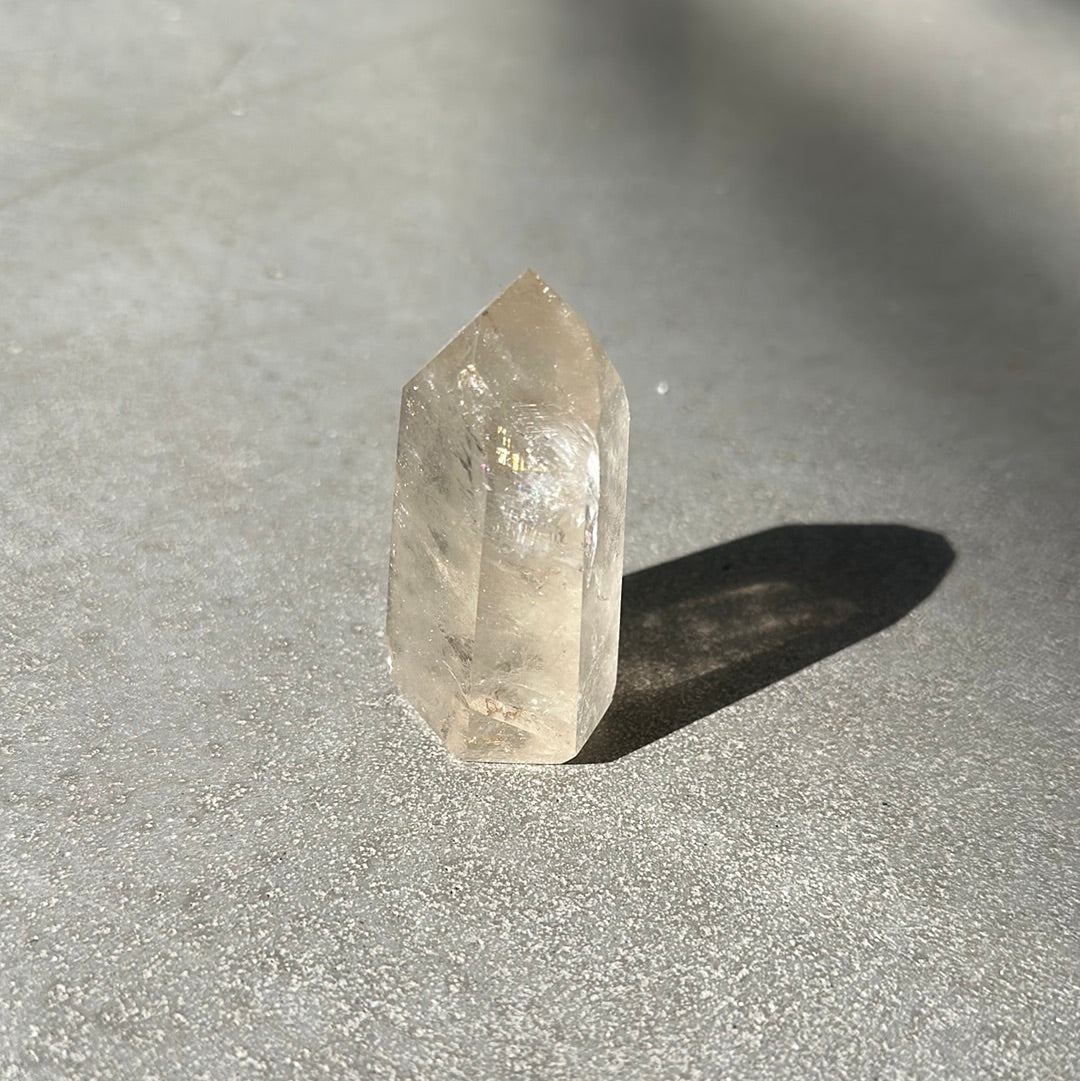 Citrine tower crystal displaying natural clarity and facets, promoting energy, prosperity, and self-confidence.