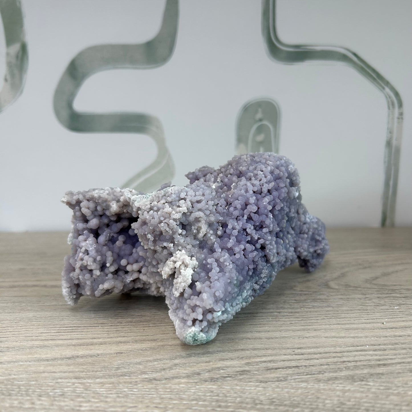Grape Agate Free Form crystal on display, known for healing properties, enhancing strength, purification, and stress relief.