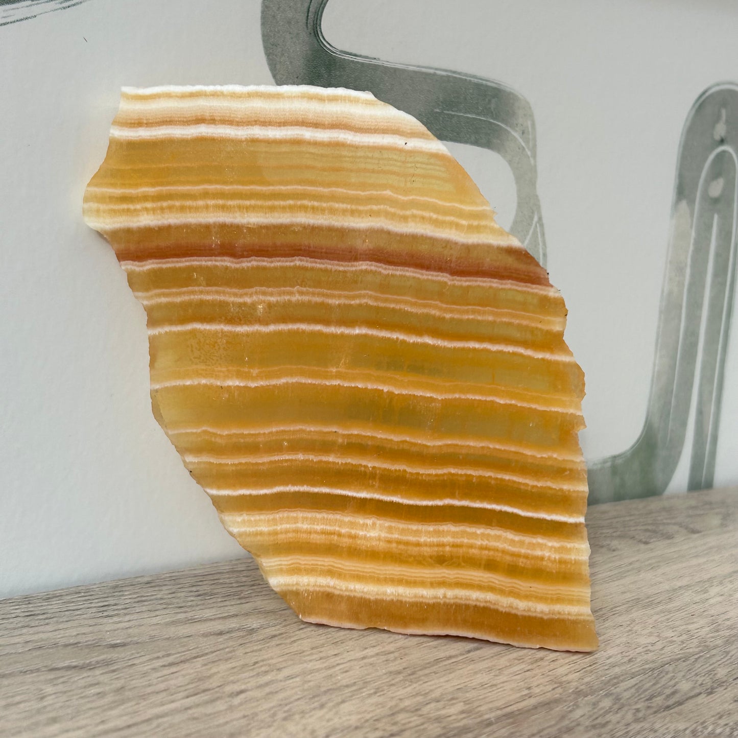 Beautiful orange calcite slab with natural striping, perfect for home décor and energy balancing.