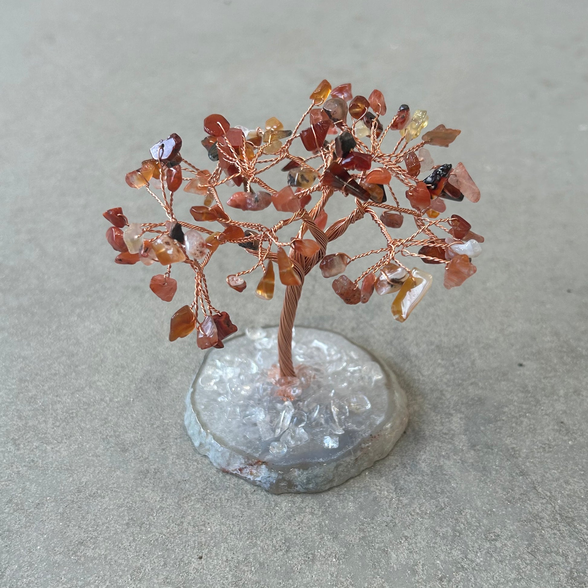 Carnelian gemstone Tree of Life on agate base, promoting vitality, creativity, courage, and positive choices.