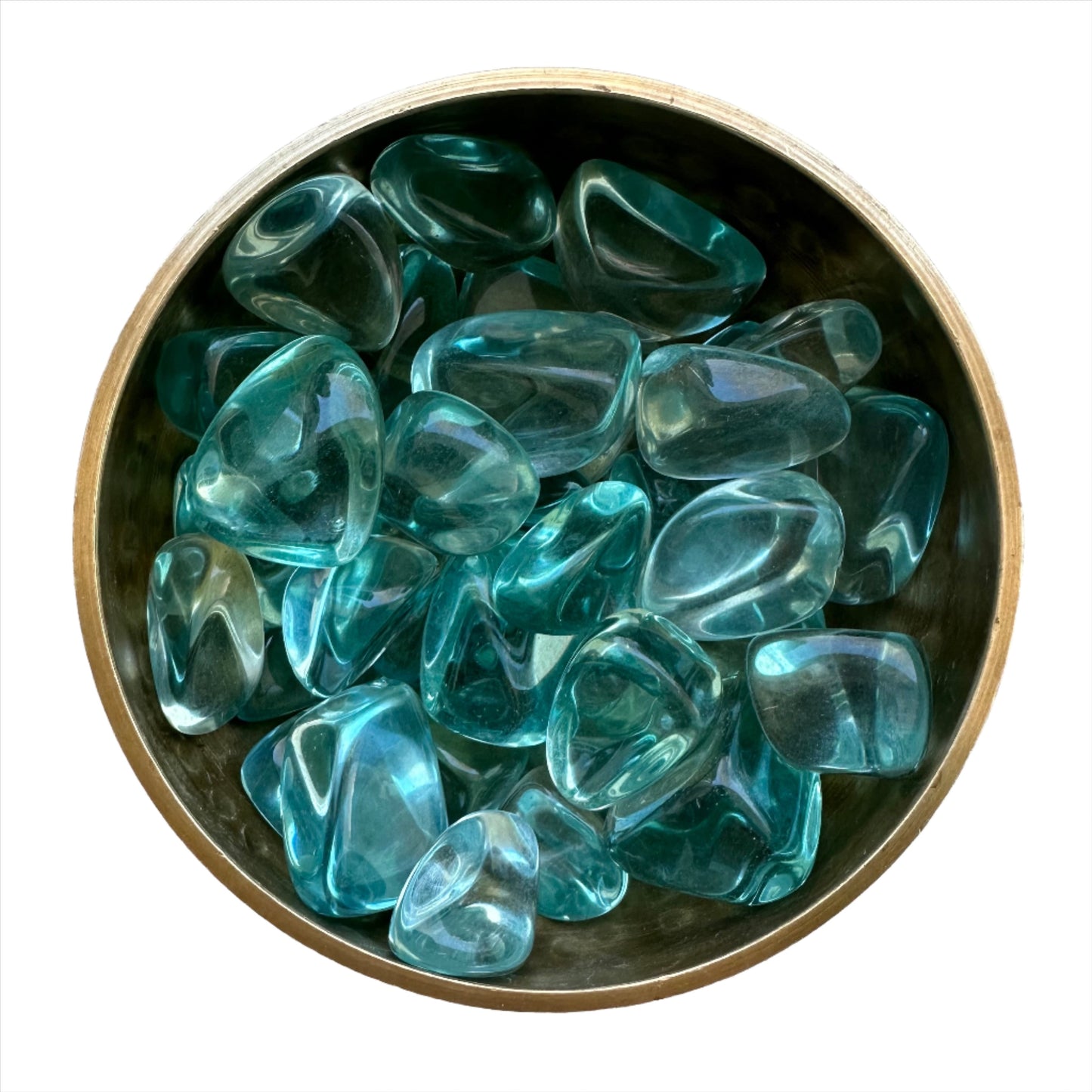 Aqua Obsidian tumbled stones in a decorative bowl, showcasing their vibrant blue color and smooth, glassy texture.