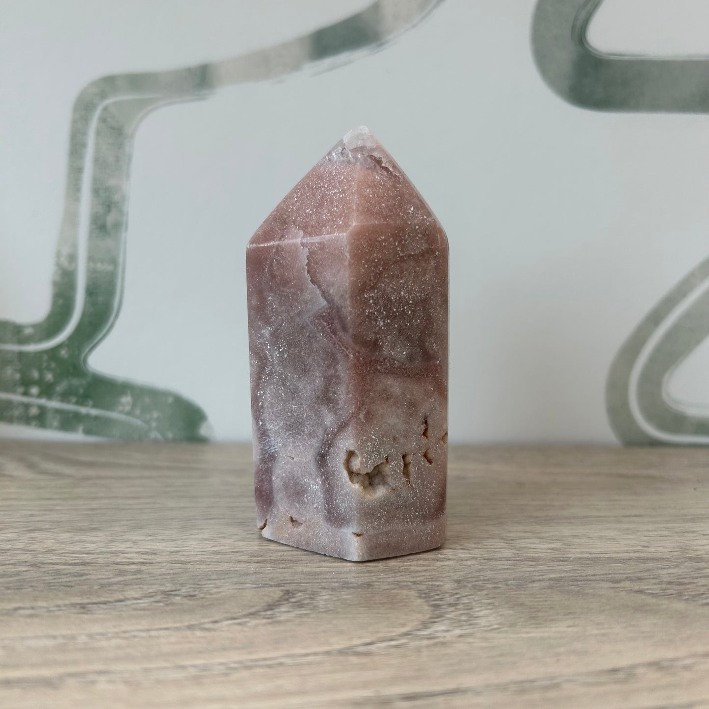 Polished 3.5" agate tower for holistic healing, rebalancing energy, and transforming negativity, placed on a wooden surface.