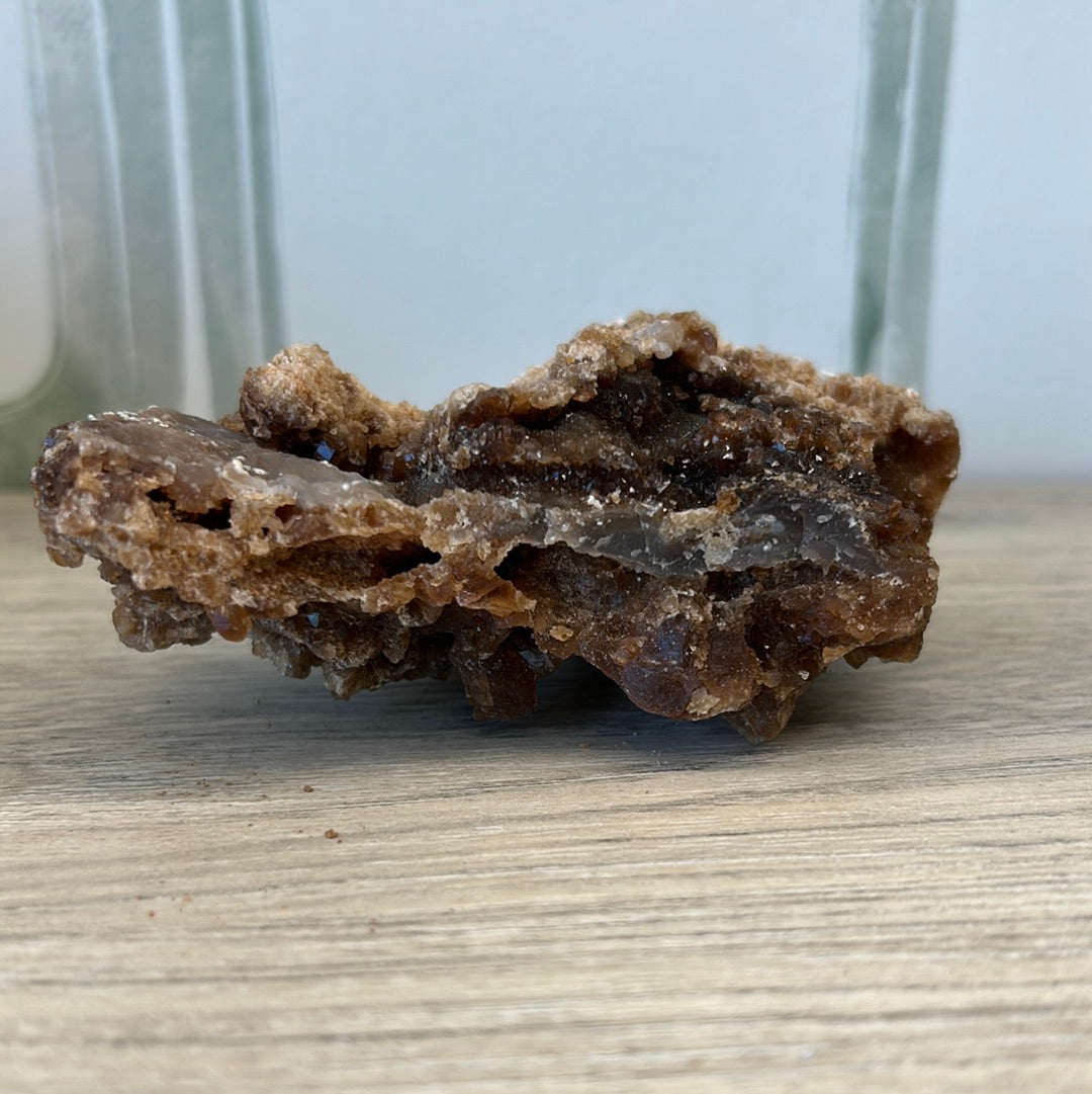 Raw Citrine Druze crystal weighing 193g, promoting energy, wealth, and self-confidence in a natural setting.
