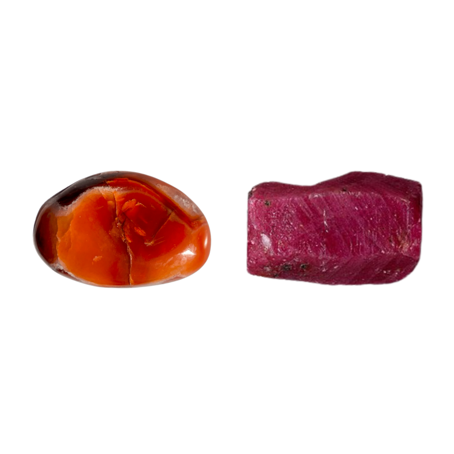 Polished red amber stone and raw reddish-purple gemstone on a white background.