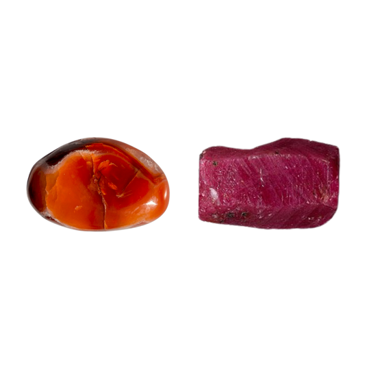Polished red amber stone and raw reddish-purple gemstone on a white background.
