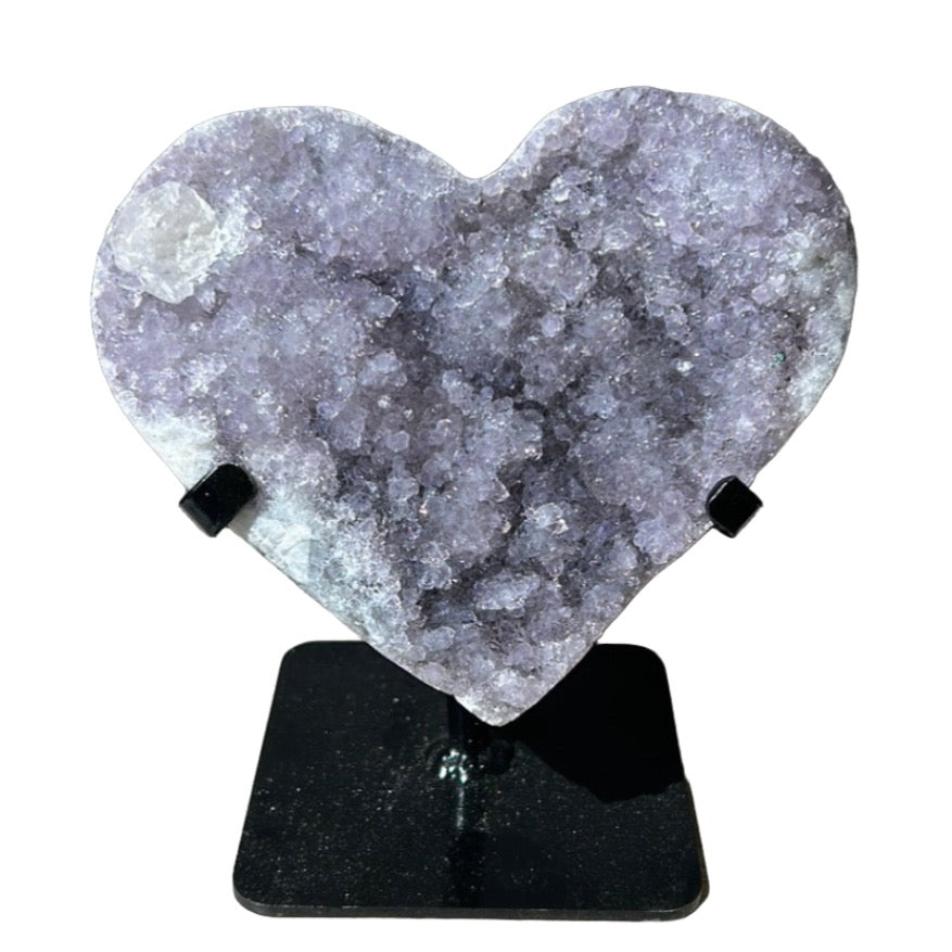 Amethyst heart healing crystal on a stand, promotes stress relief and mood stabilization, enhances spiritual and physical well-being.