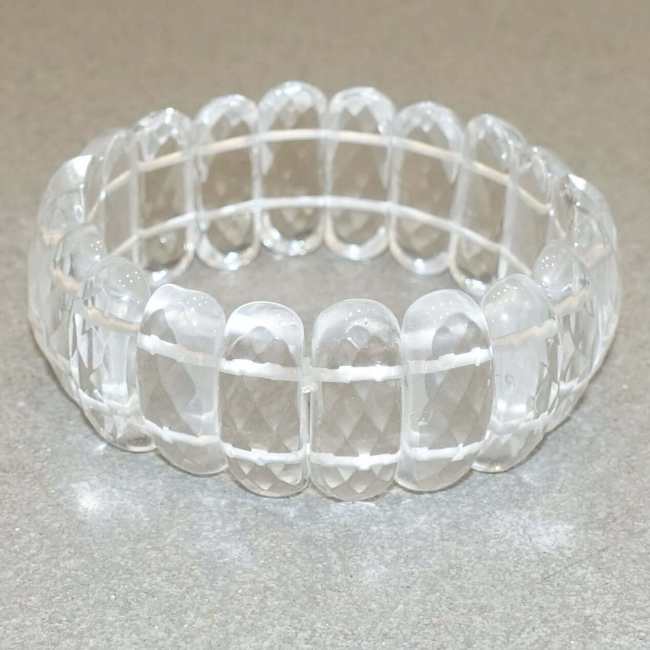 Clear quartz faceted bracelet 24MM featuring polished gemstones on an elastic band for an elegant and versatile look.
