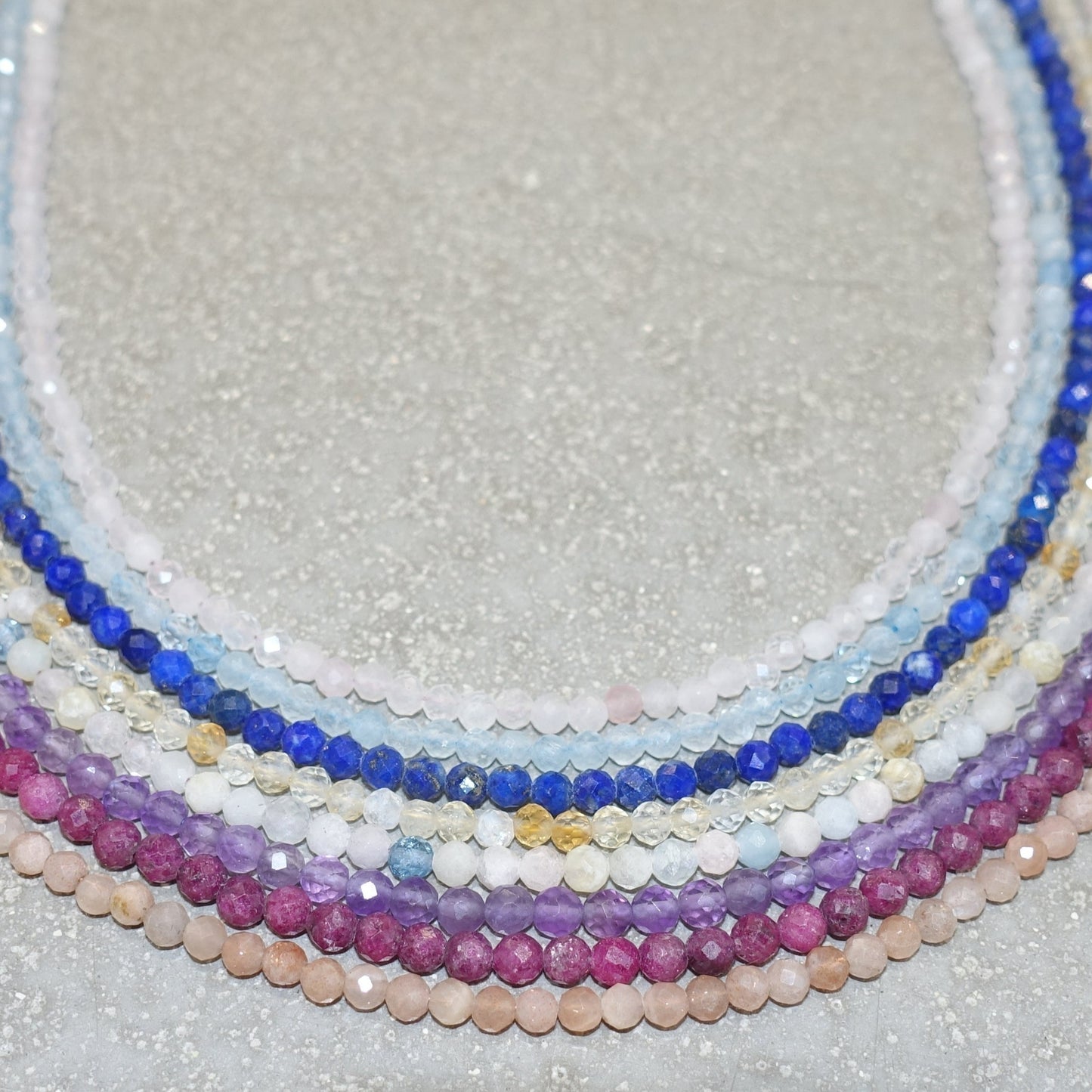 Multicolored faceted necklaces and bracelets with 3mm beads, featuring amethyst for stress relief and mood stabilization.