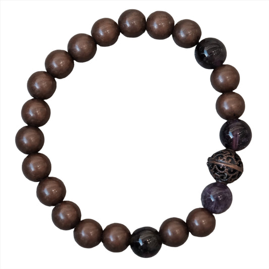 Copper bracelet with dark beads, believed to enhance energy and promote optimism, featuring a decorative accent bead.