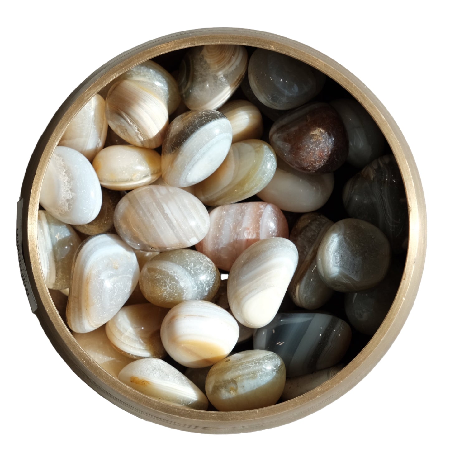 Banded agate tumbled stones in a bowl, promoting balance and harmony with healing properties for body and mind.
