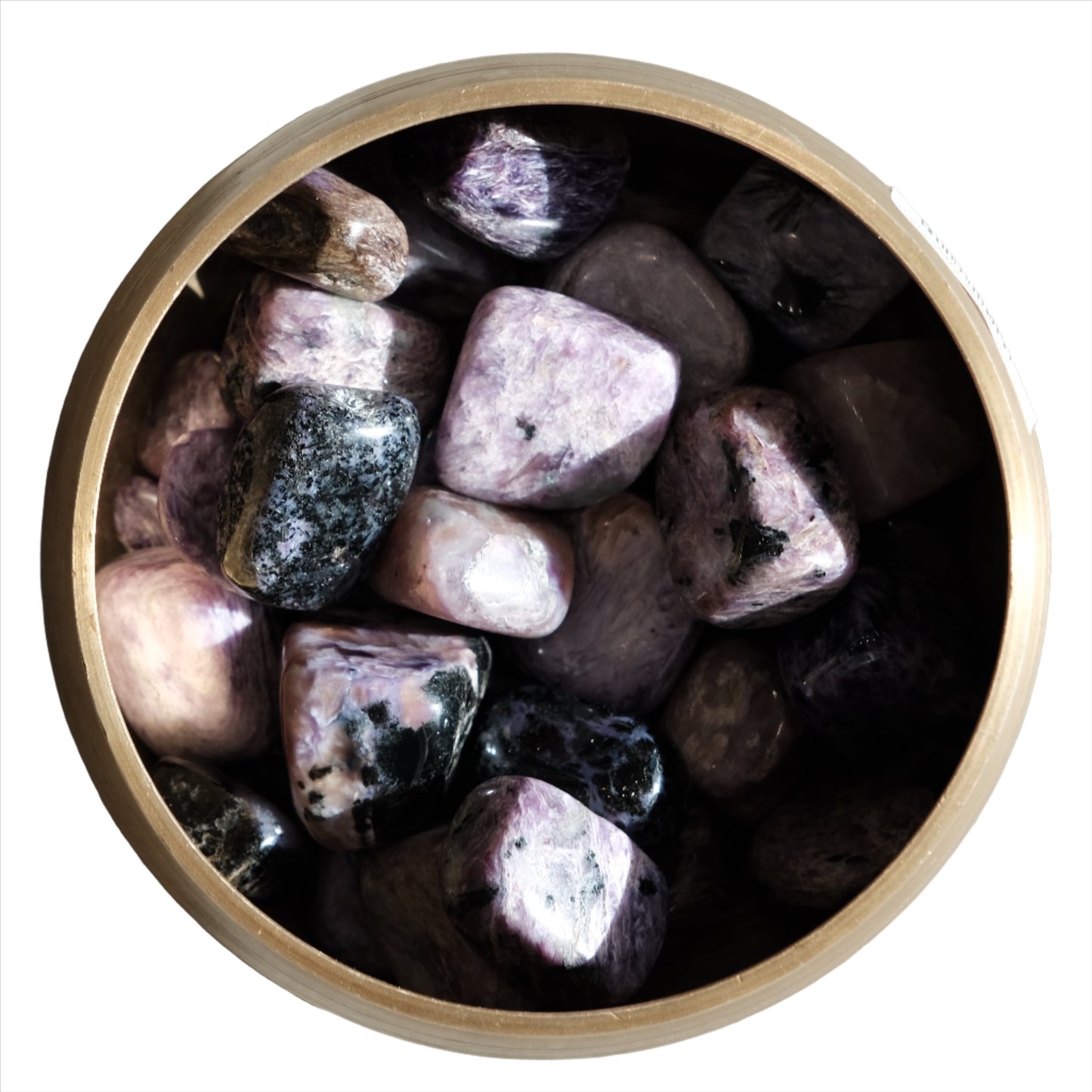 A collection of Charoite tumbled stones in a wooden bowl, showcasing their purple and black hues for aura cleansing and stress reduction.