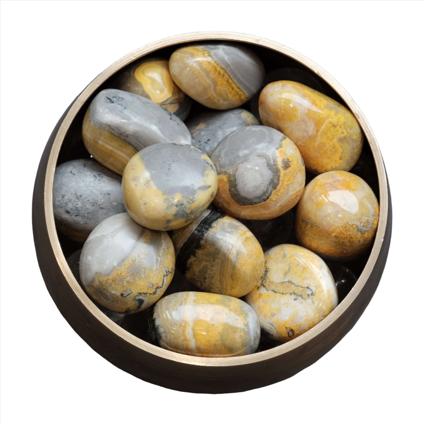 Bumble Bee Jasper tumbled stones in a bowl, showcasing vibrant yellow and gray patterns for energy and creativity boost.