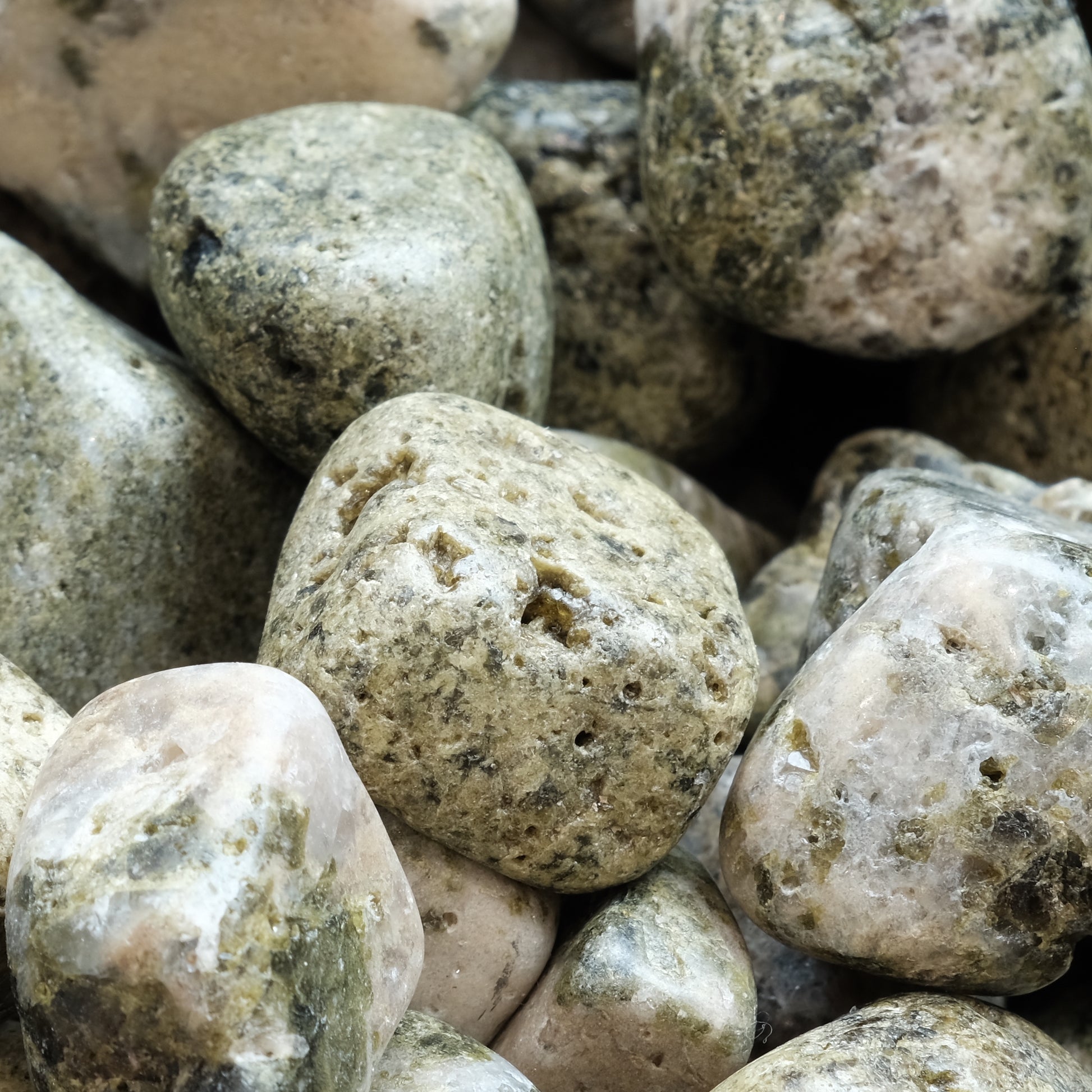 Tumbled Epidote with Quartz stones, 20-30mm, showcasing green-yellow hues and believed to offer calming and healing properties.