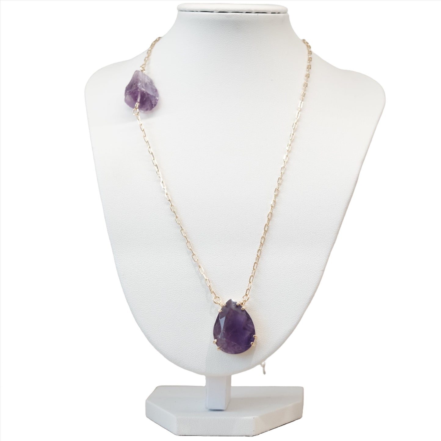 Elegant amethyst drop necklace with natural healing properties on a display bust, relieves stress and enhances clarity.