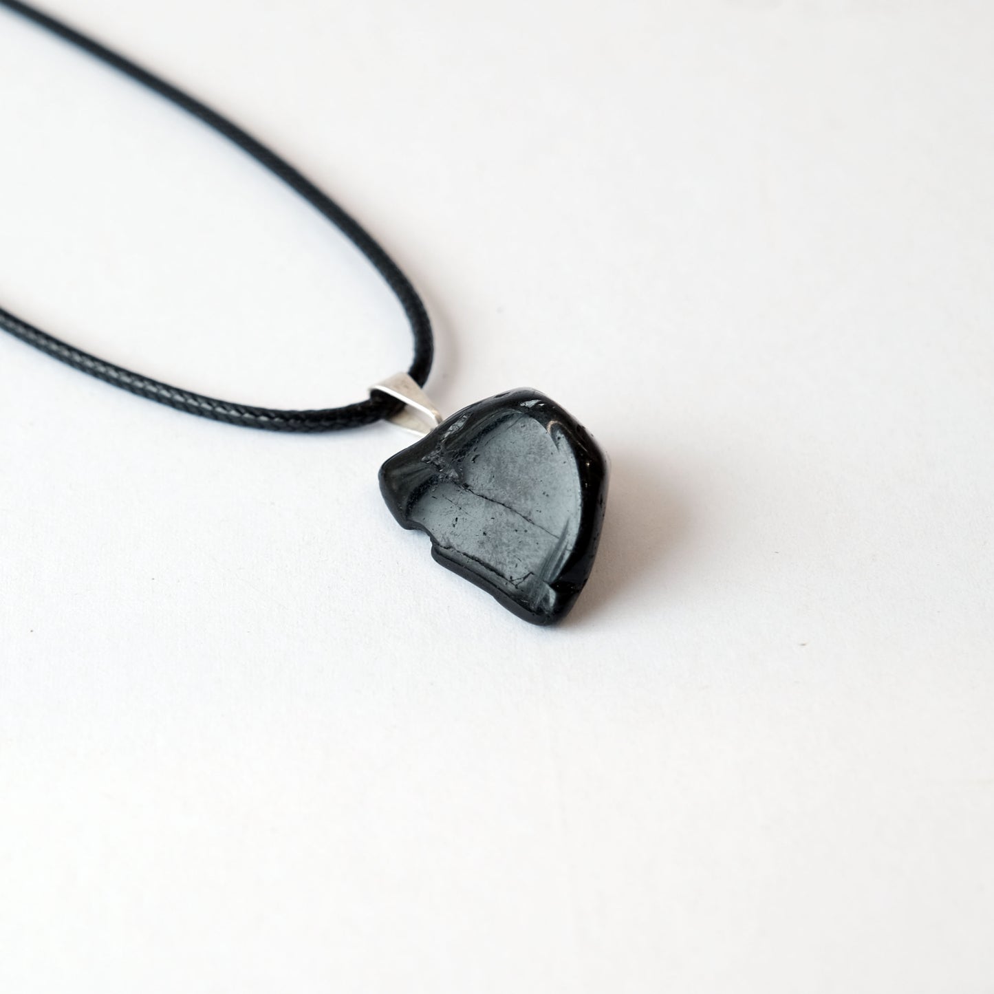Black Tourmaline Tumbled Stone Pendant Necklace on black cord for energy protection and grounding.