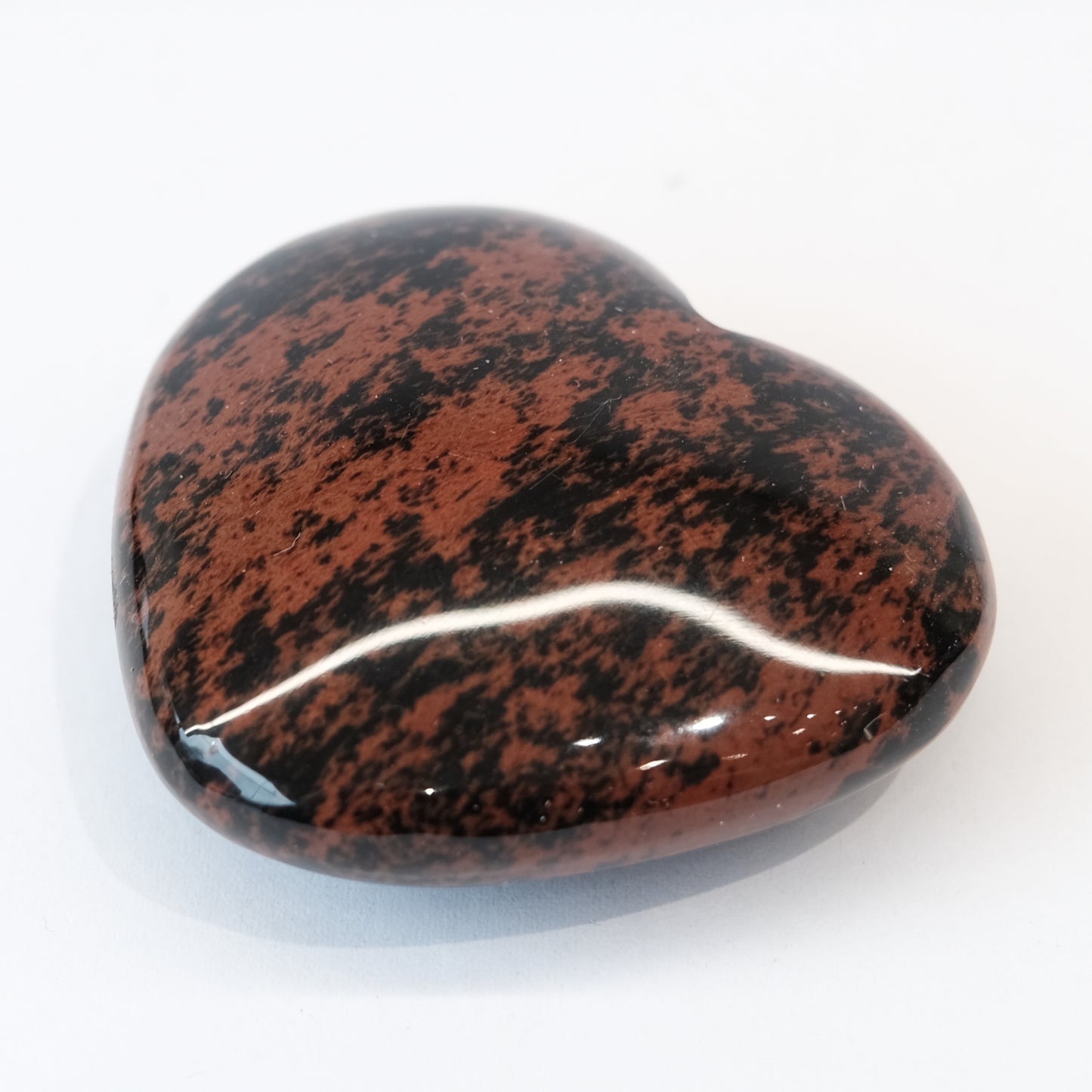 Mahogany obsidian heart shaped stone promoting emotional healing and balance, approx 40MM in size.