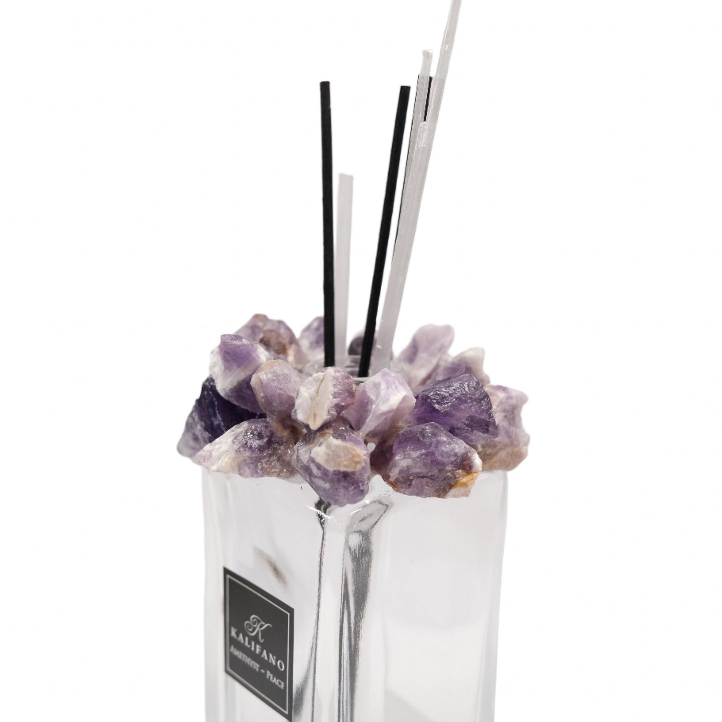 Amethyst diffuser with healing crystals, featuring purple stones and fragrance sticks in a clear container.