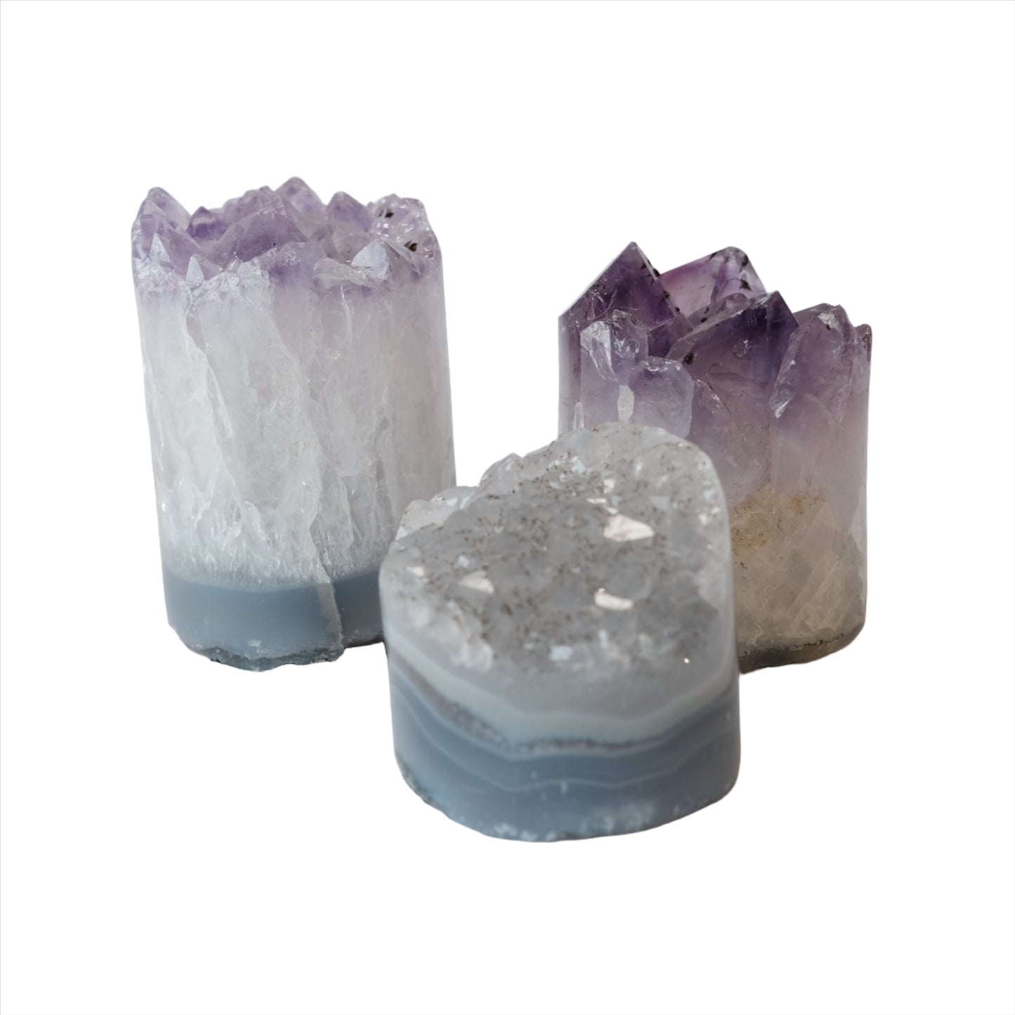 Three natural amethyst cylinders showcasing raw purple crystal formations, ideal for stress relief and enhancing spiritual clarity.