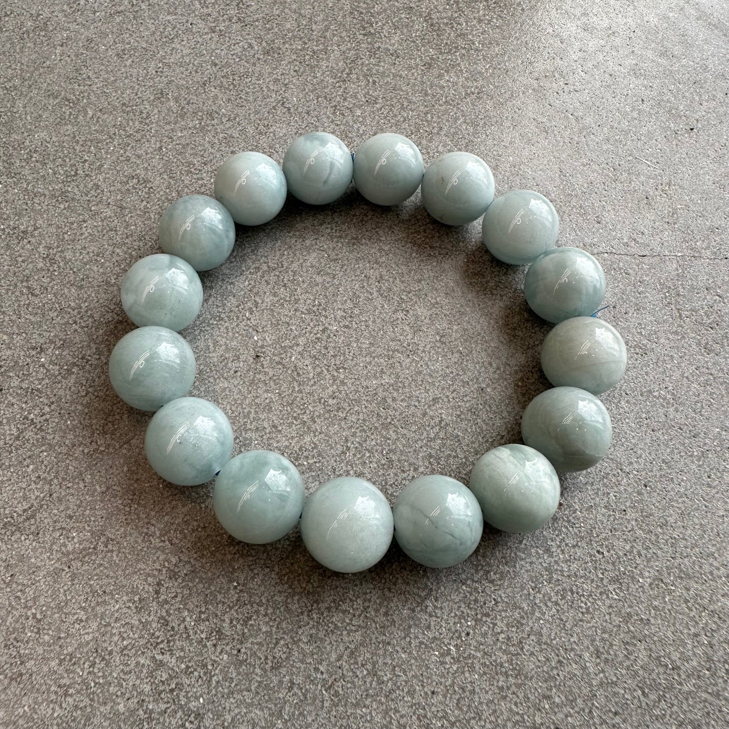 Aquamarine bracelet with 13-14mm beads, promotes courage and calmness, soothing stone to reduce stress and enhance perception.