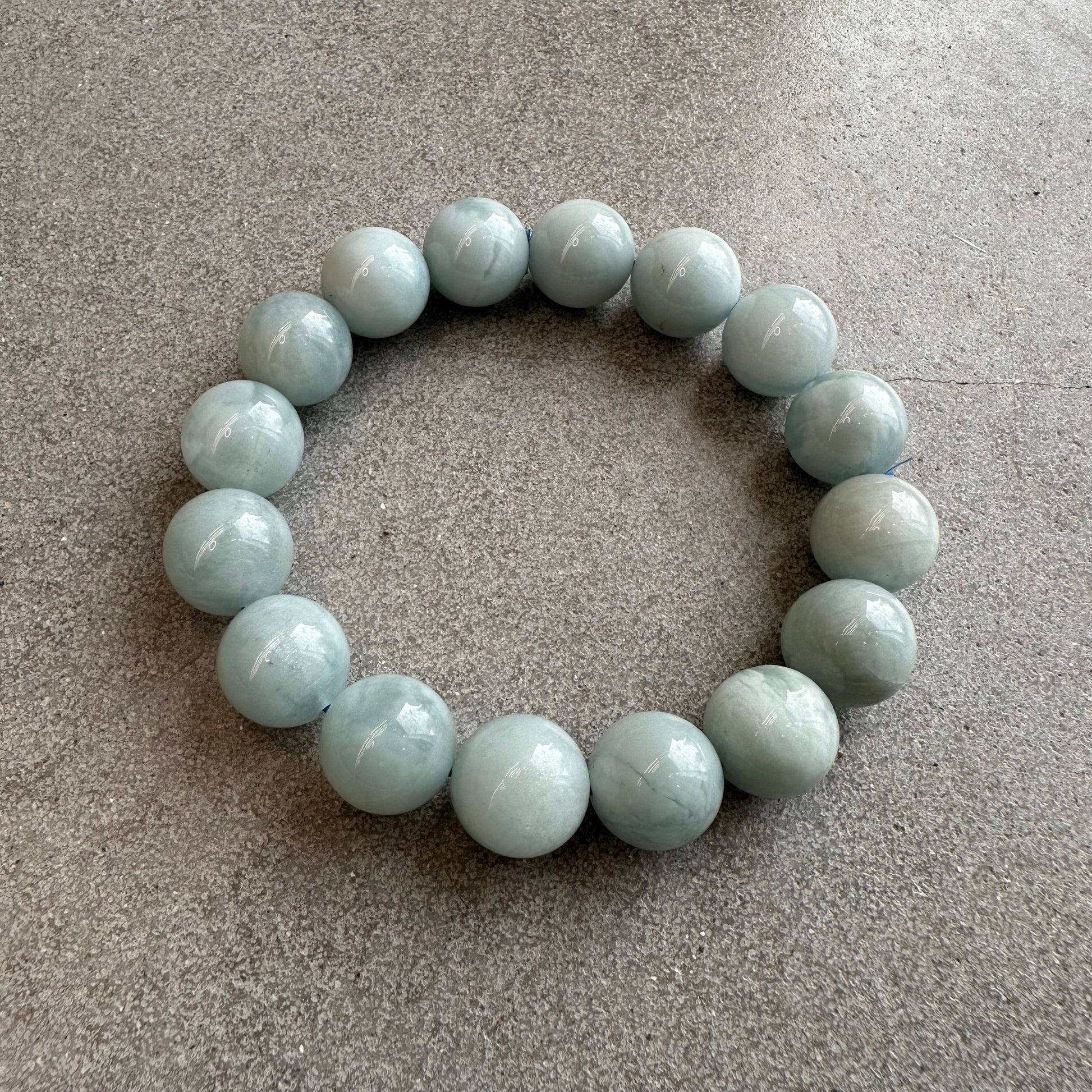 Aquamarine bracelet with 13-14mm beads, promotes courage and calmness, soothing stone to reduce stress and enhance perception.