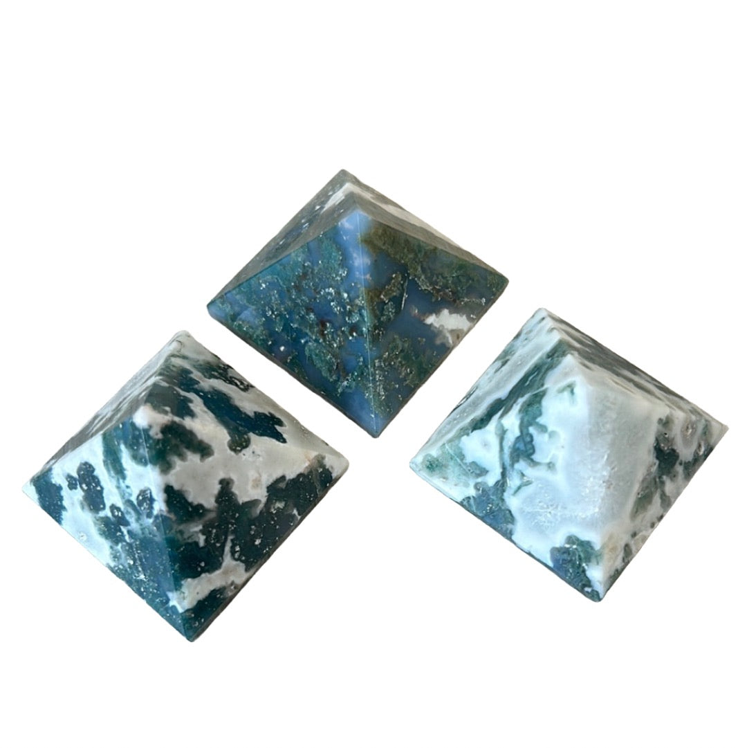 Three moss agate pyramids featuring green, moss-like inclusions, known for promoting balance, detoxifying effects, and inner peace.