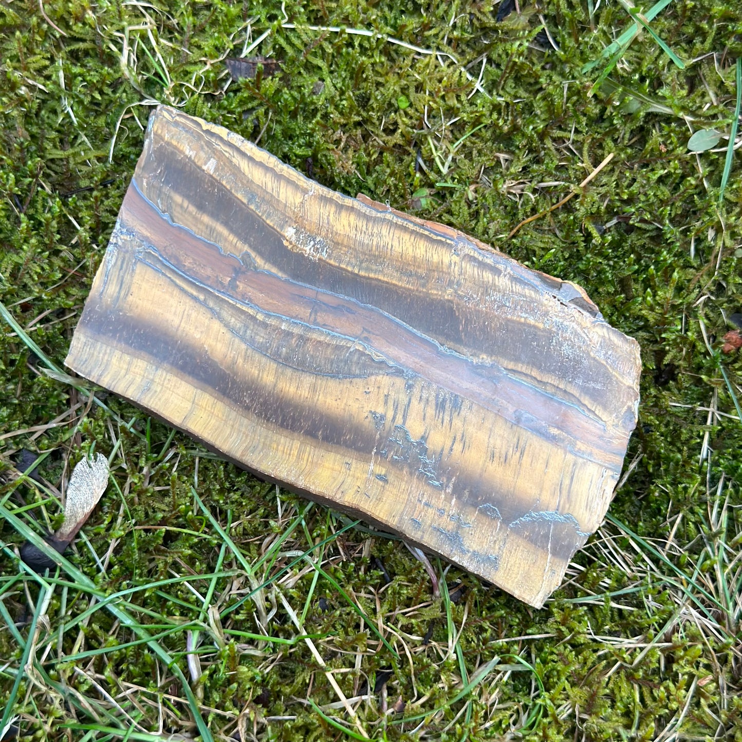 Tiger Eye slab showcasing natural hues, believed to enhance mental clarity and promote balance in life.