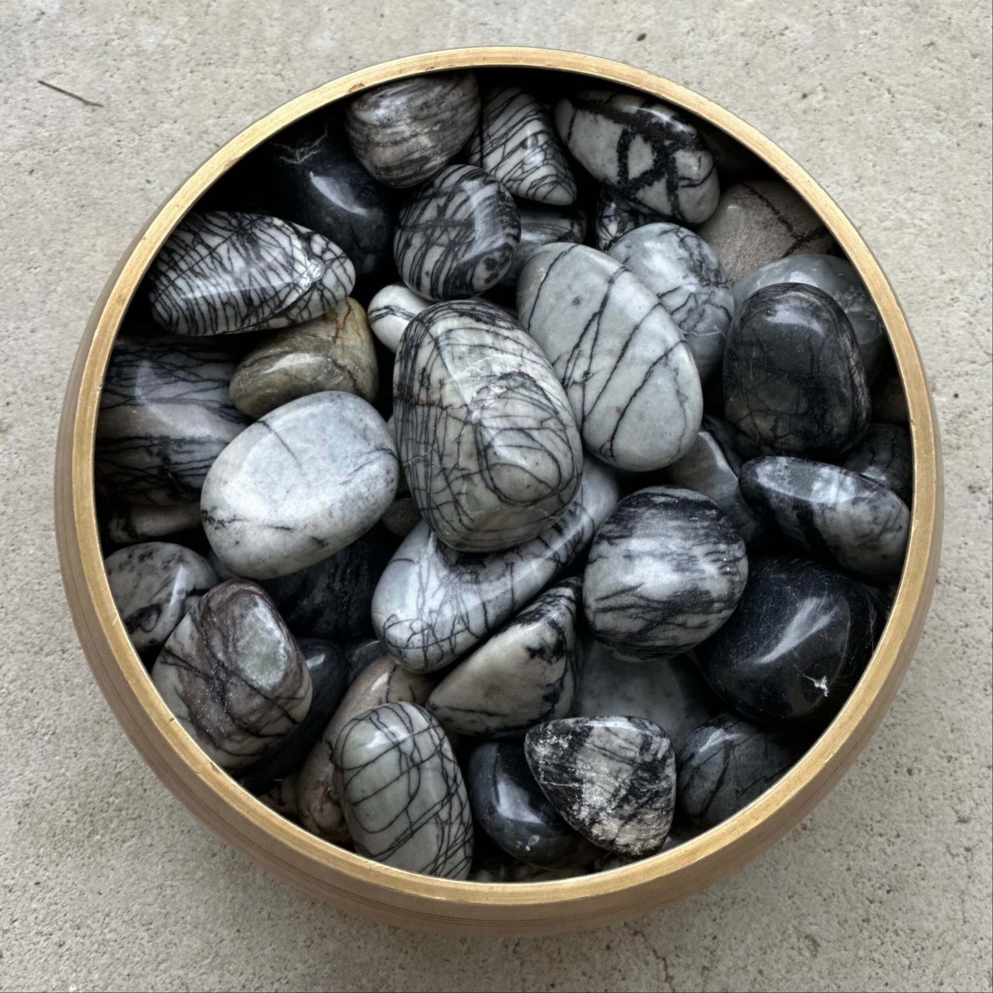 Polished Zebra Jasper tumbled stones in a wooden bowl, promoting contentment, courage, and motivation, sizes 20-30MM.