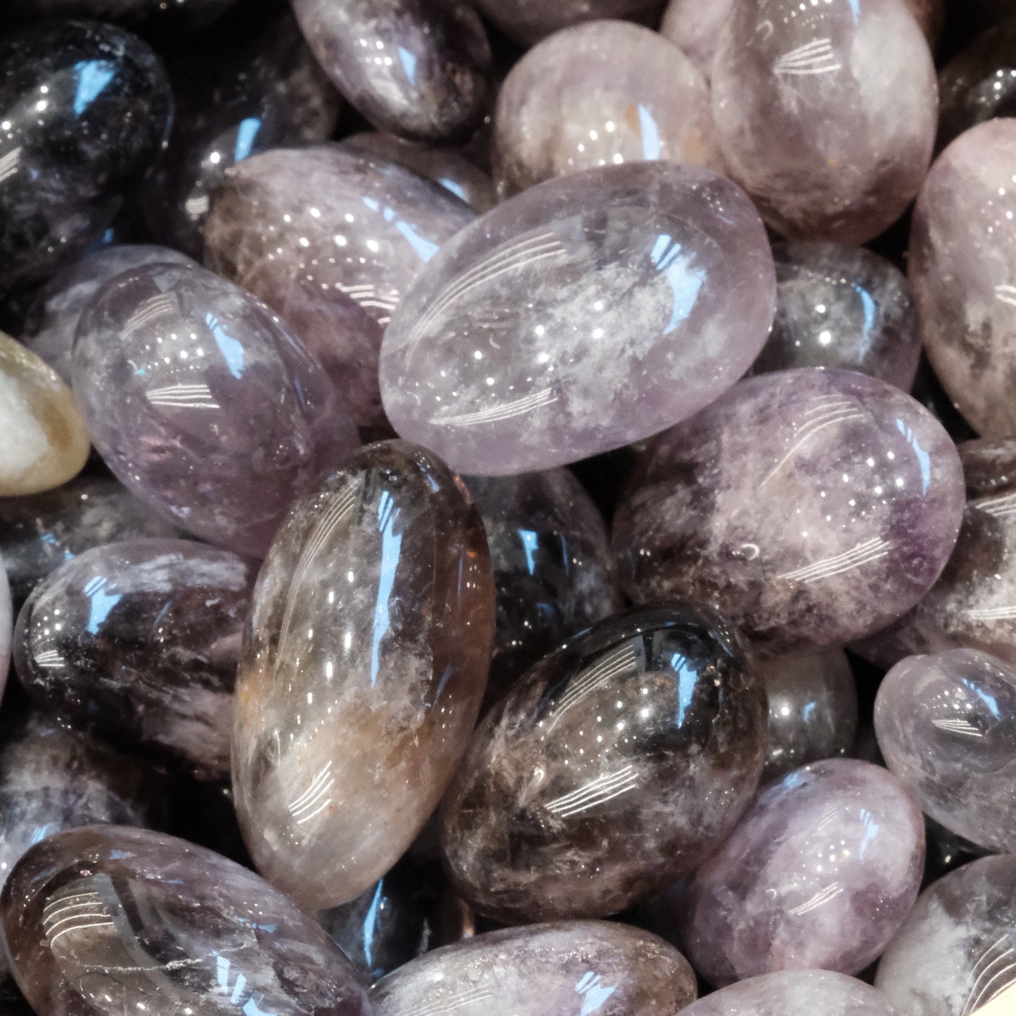 Ametrine tumbled stones, 20-40 mm size, known for promoting calm, enhancing creativity, and balancing emotions.