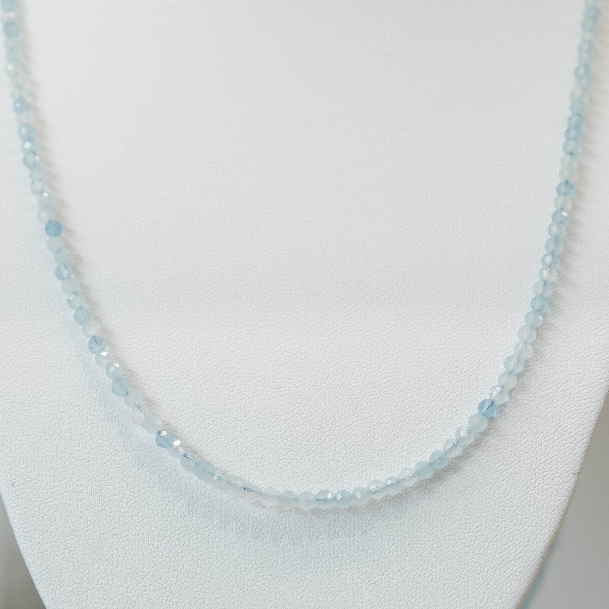 Aquamarine faceted 31" necklace and multi wrap bracelet, 3MM beads, promoting calmness and courage, elegant design on display.