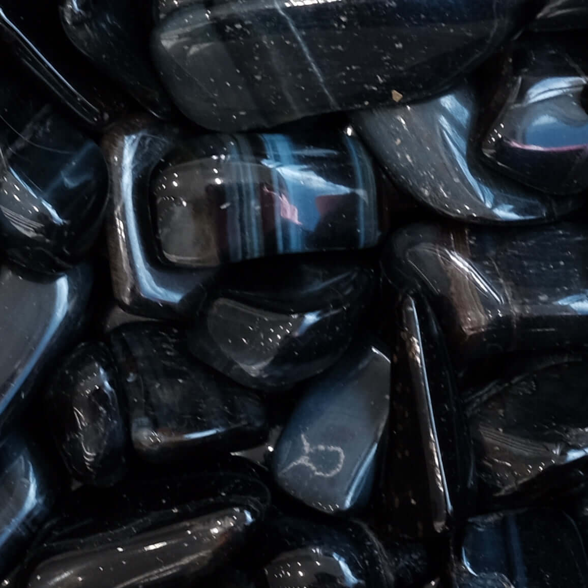 Blue Tiger Eye Hawk's Eye Tumbled Stones with striking blue hues and subtle grey streaks for enhancing perception and security.