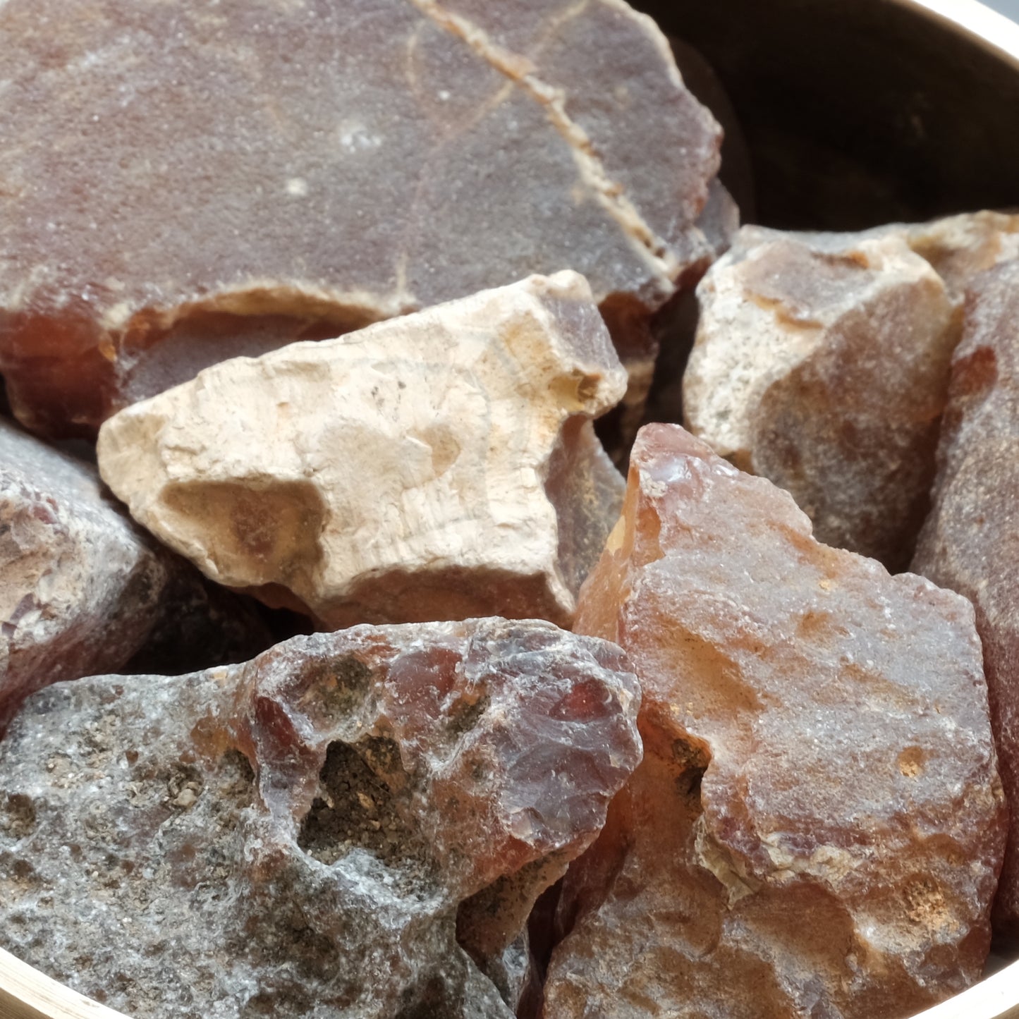 Carnelian rough stones in various sizes, promoting vitality, creativity, and healing properties.
