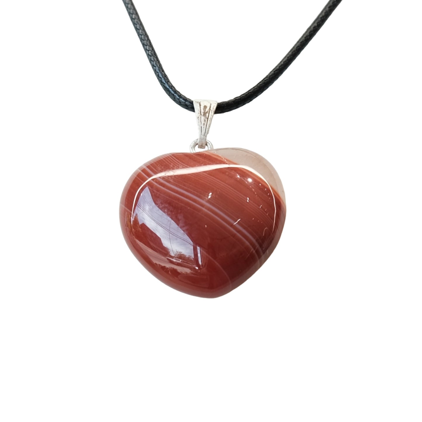 Carnelian heart pendant necklace on black cord, promoting vitality, creativity, and emotional healing.