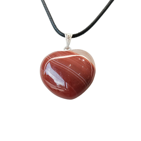 Carnelian heart pendant necklace on black cord, promoting vitality, creativity, and emotional healing.