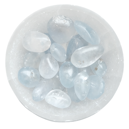 Celestite tumbled stones in a white bowl, promoting peace and energetic healing.