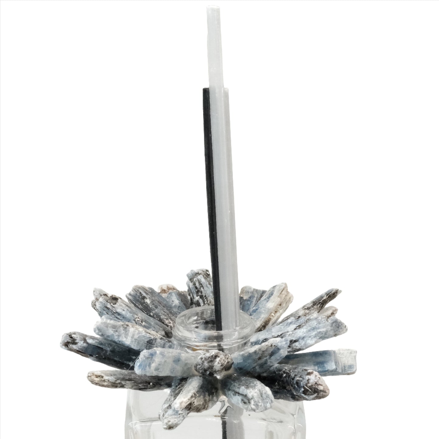 Kyanite diffuser with blue crystal design and reed sticks in a glass container for aromatherapy.