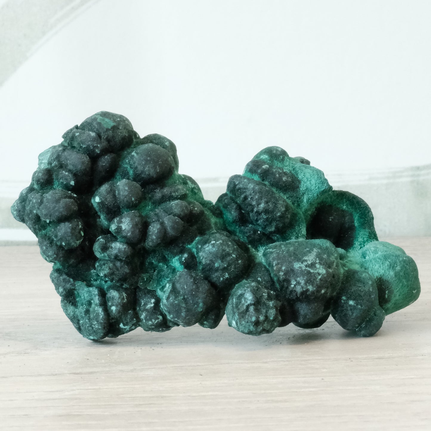 Raw malachite stone weighing 70g, showcasing its vibrant green color and natural texture, known for its healing properties.