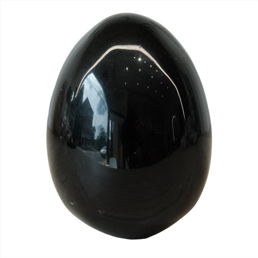 Glossy obsidian egg, approximately 1.7 inches, known for protection and enhancing truth. Perfect for mental clarity.