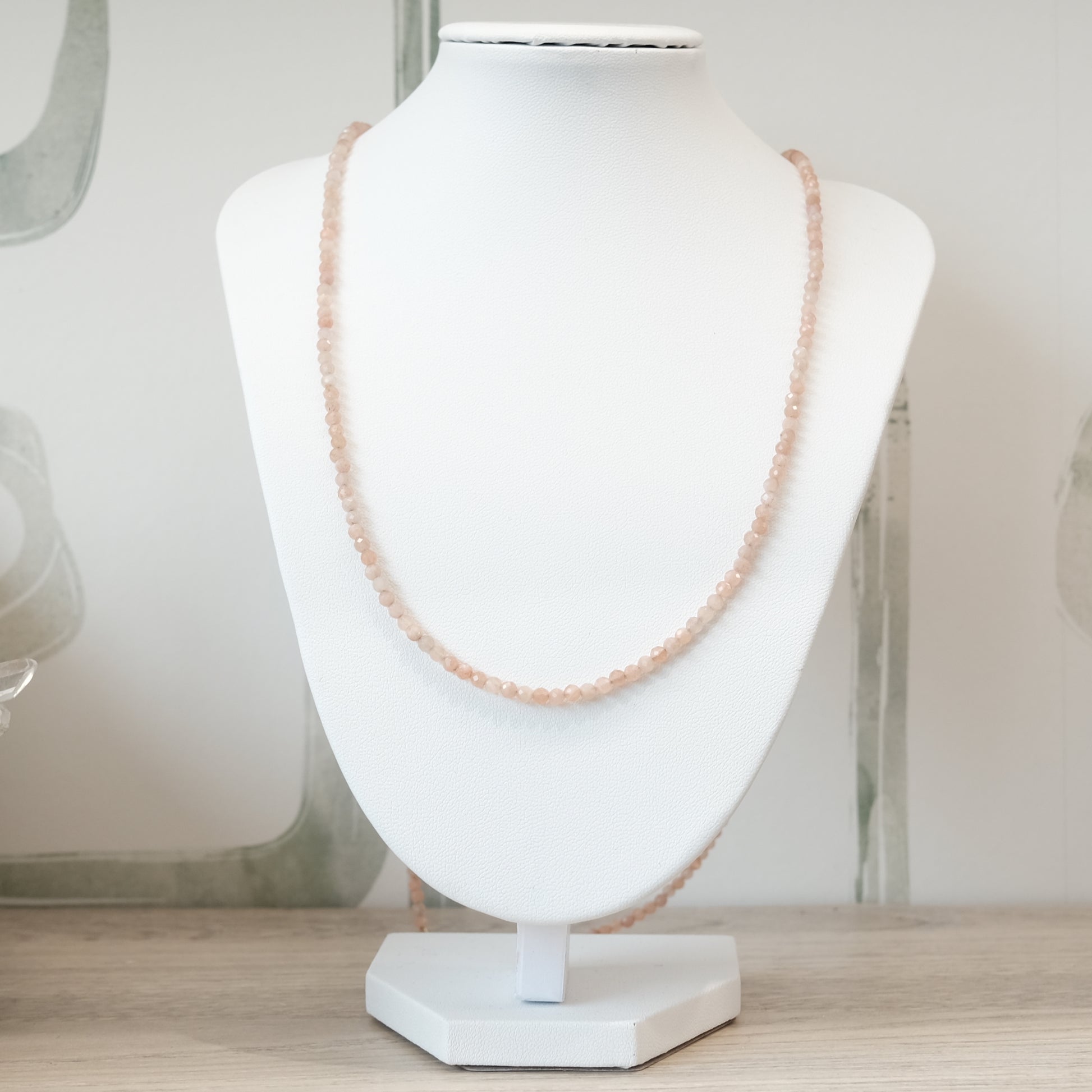 Peach Moonstone Faceted Necklace and Multi Wrap Bracelet on Display Stand