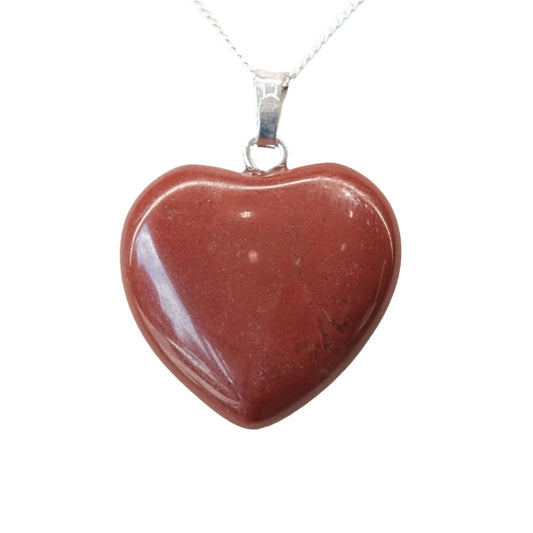 Small red jasper heart pendant on a silver chain, known for protection and soothing emotions.