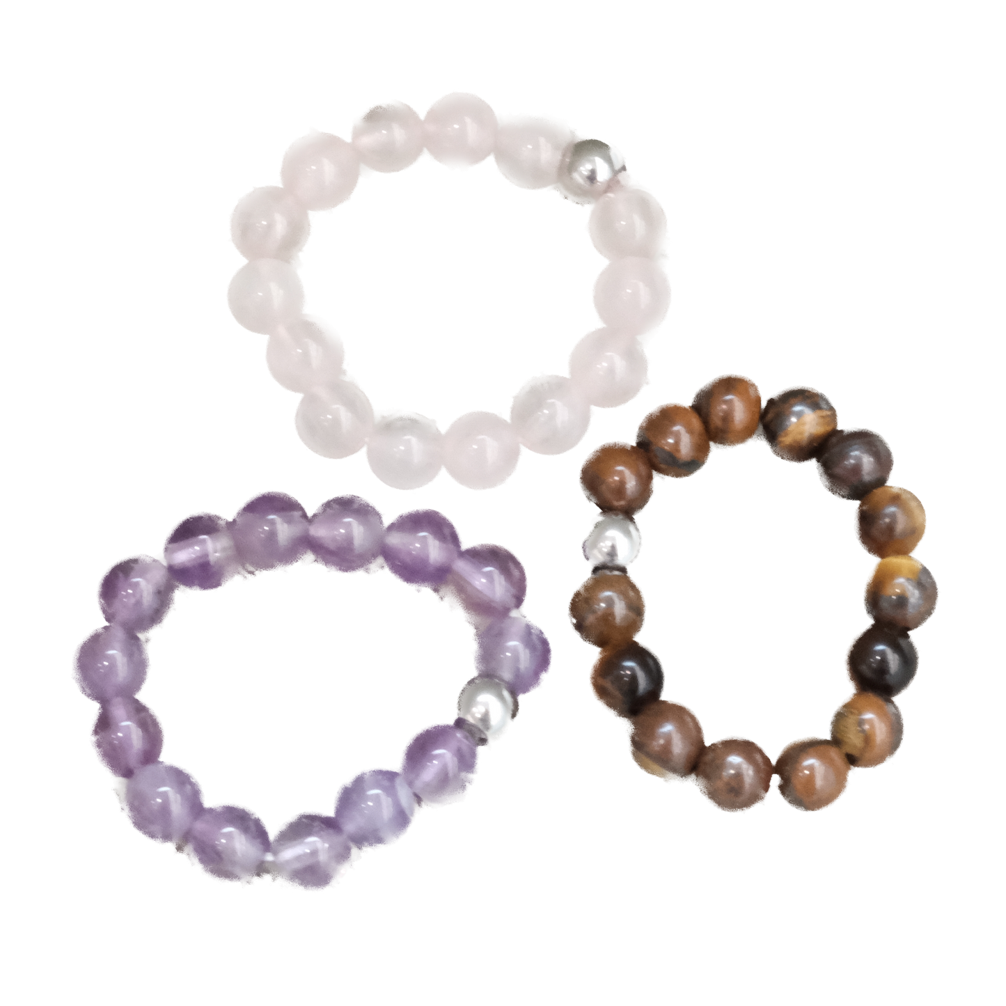 Three stretch rings made of rose quartz, amethyst, and tiger eye, showcasing their natural beauty and healing properties.